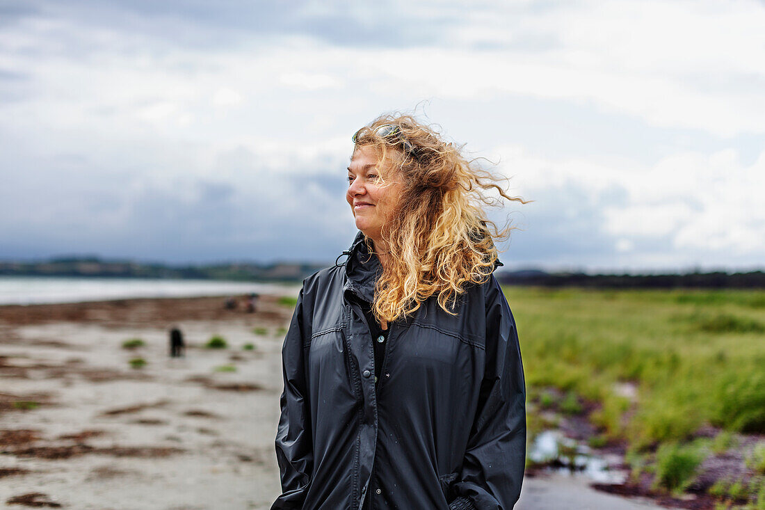 Smiling woman standing on beach