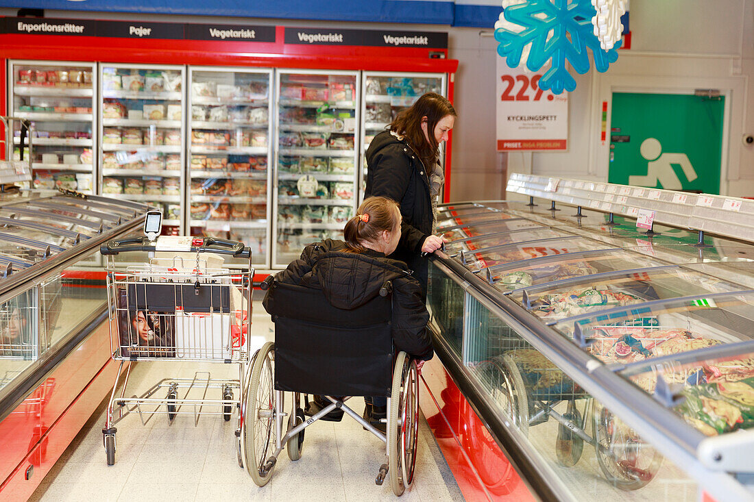 Female carer helping woman with shopping