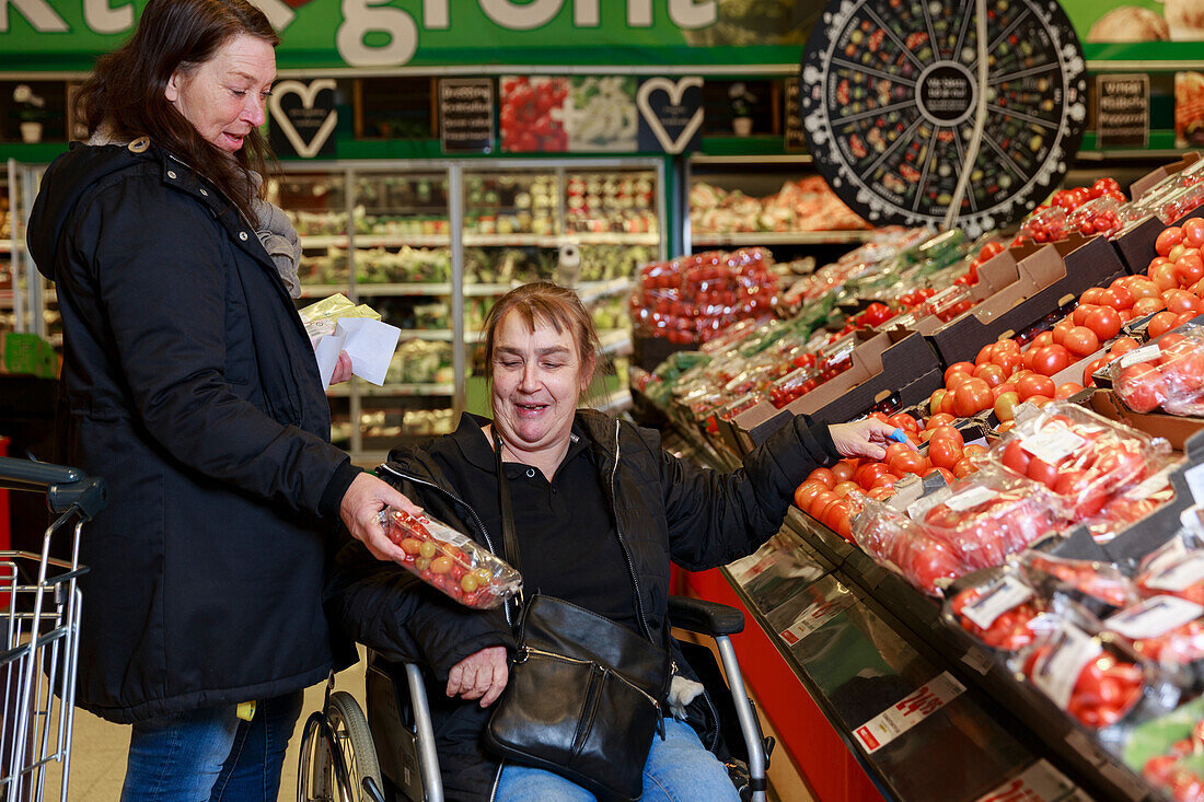 Female carer helping woman with shopping