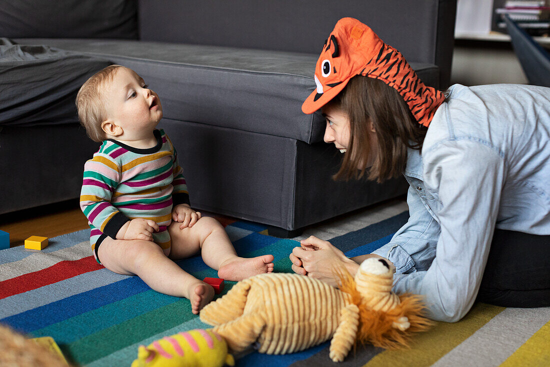 Mother playing with baby at home