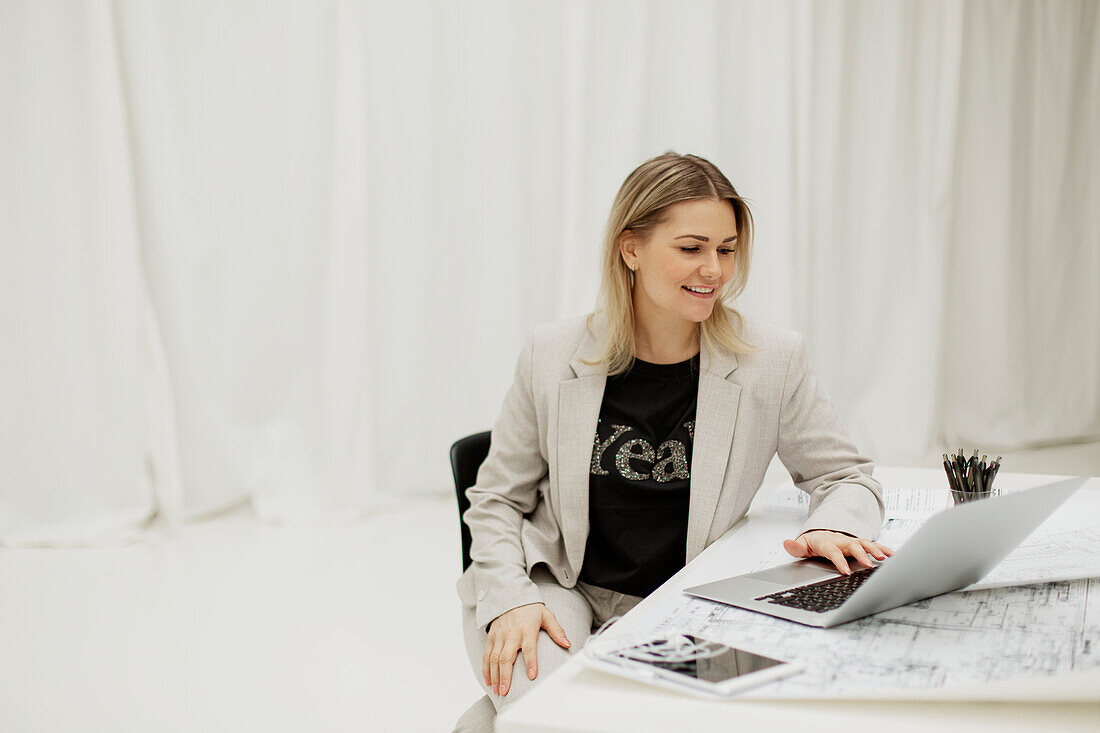 Businesswoman in office using laptop