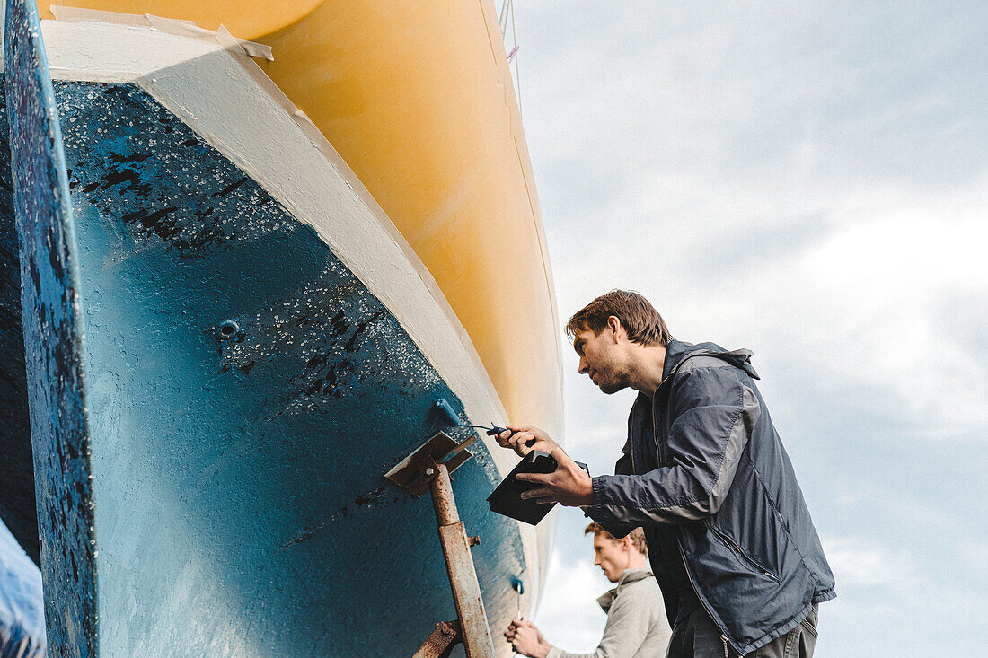 Men painting boat