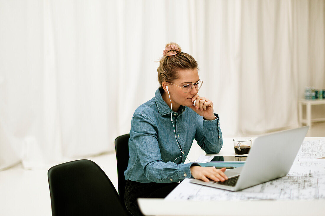 Businesswoman using laptop in office