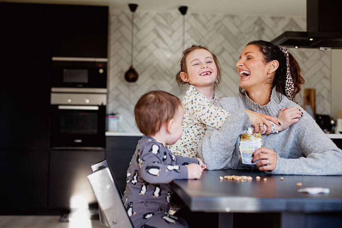 Mother with children at table