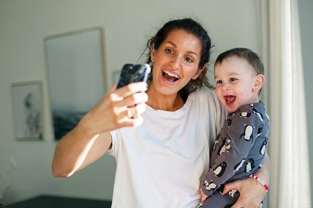 Mother taking selfie with toddler son