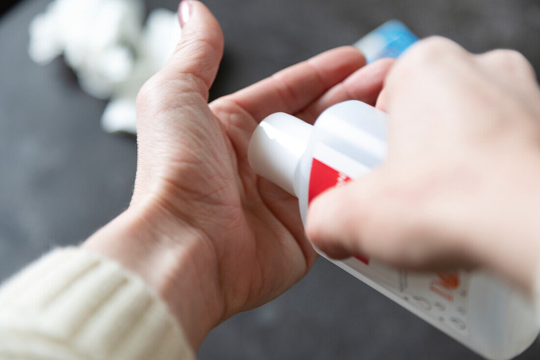 Woman applying hand sanitizer