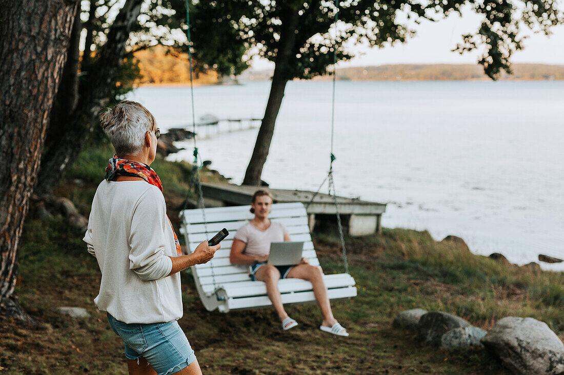 Woman in garden talking to adult son