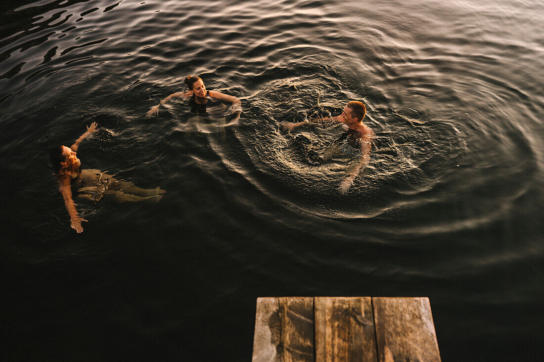 High angle view of friends swimming