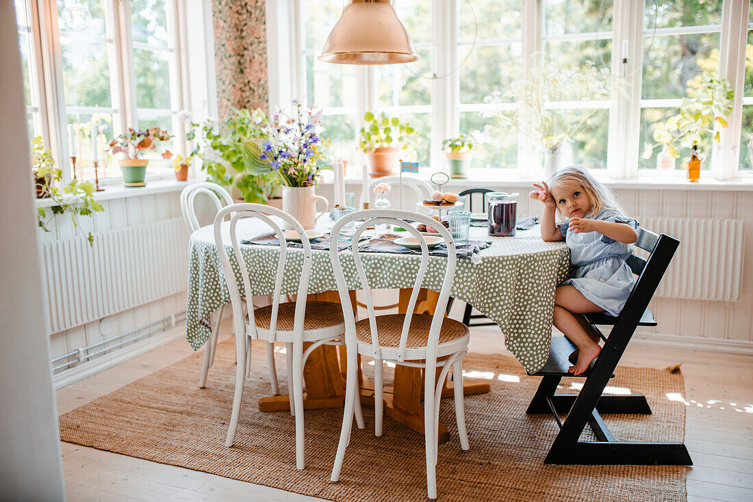 Girl sitting at dining table