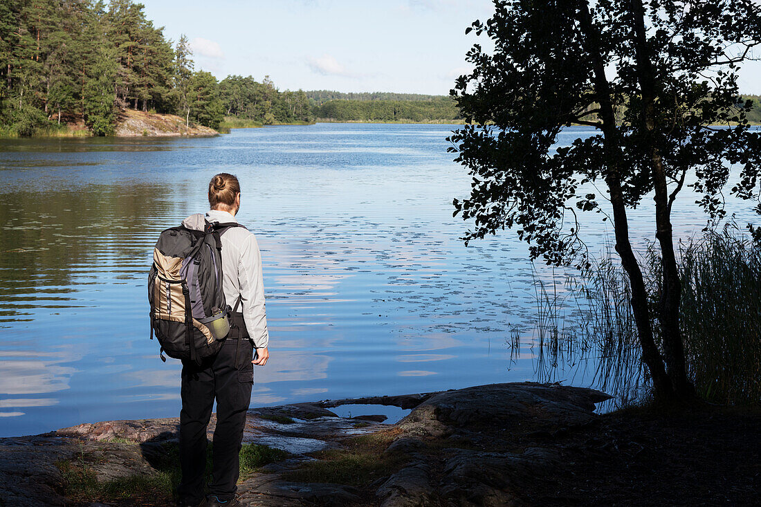 Hiker standing at lake