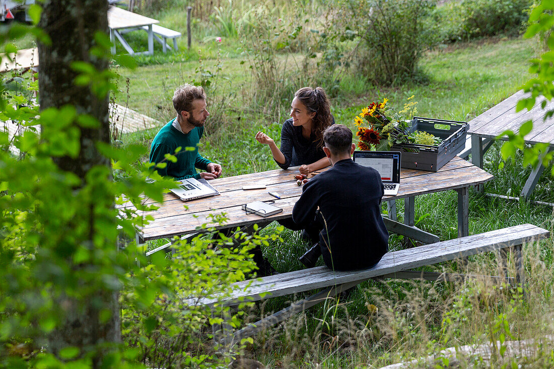 Woman and men at picnic bench