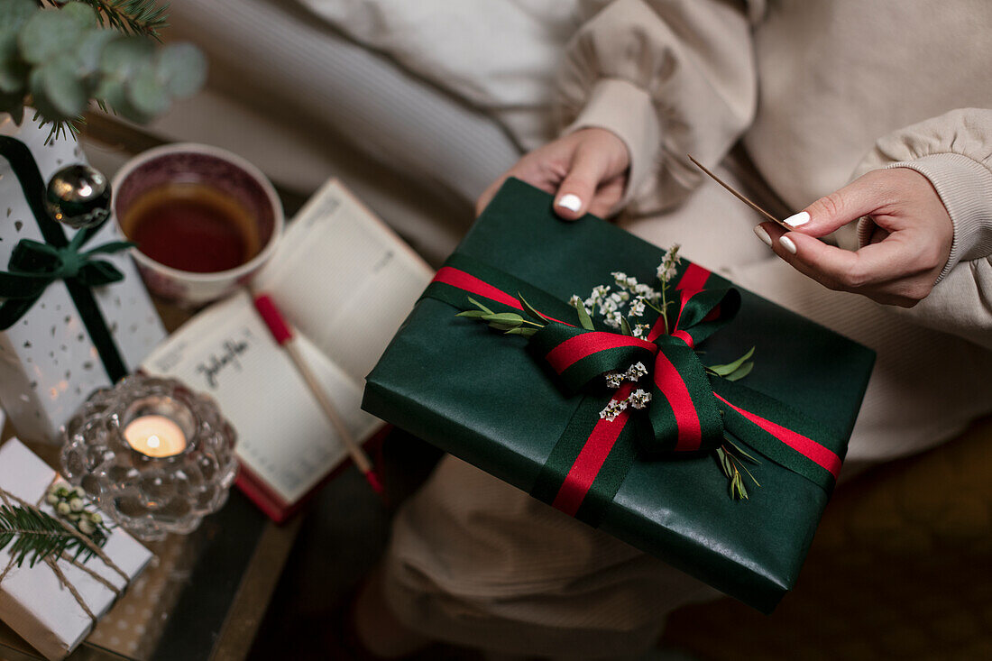 Womans hands holding Christmas present