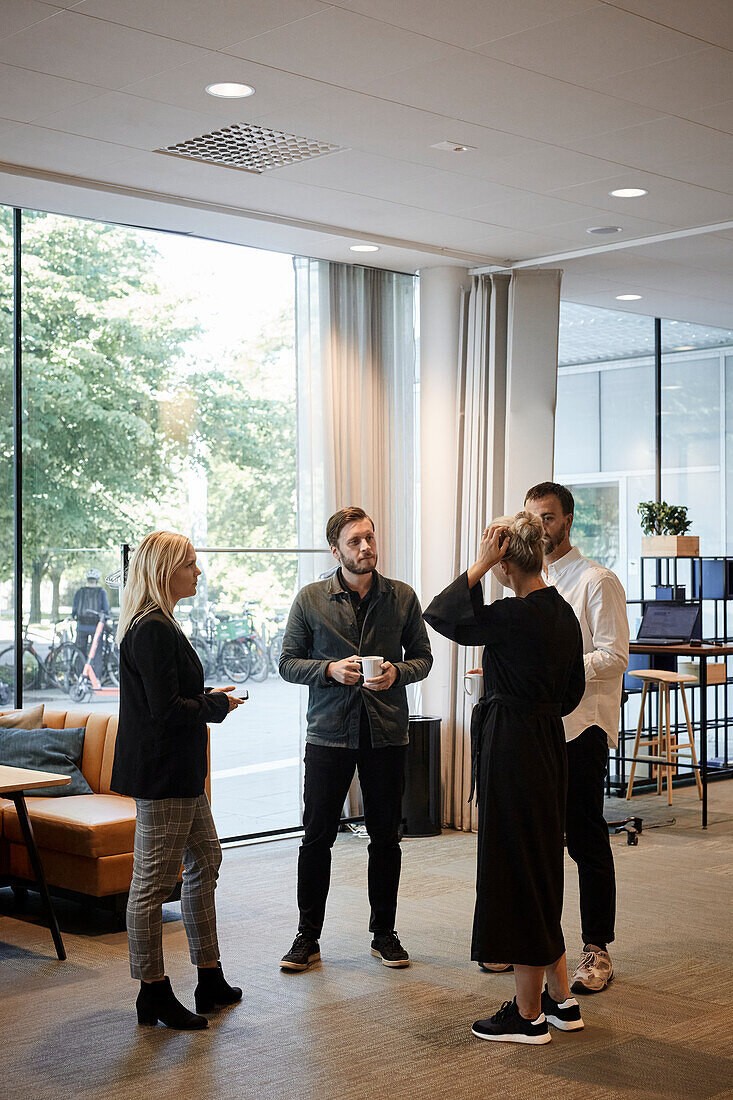 Coworkers talking during coffee break