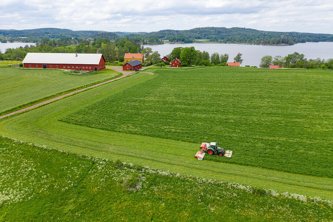 Tractor mowing field