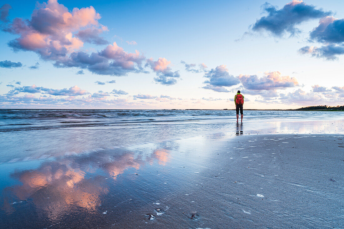 Hiker standing at sea