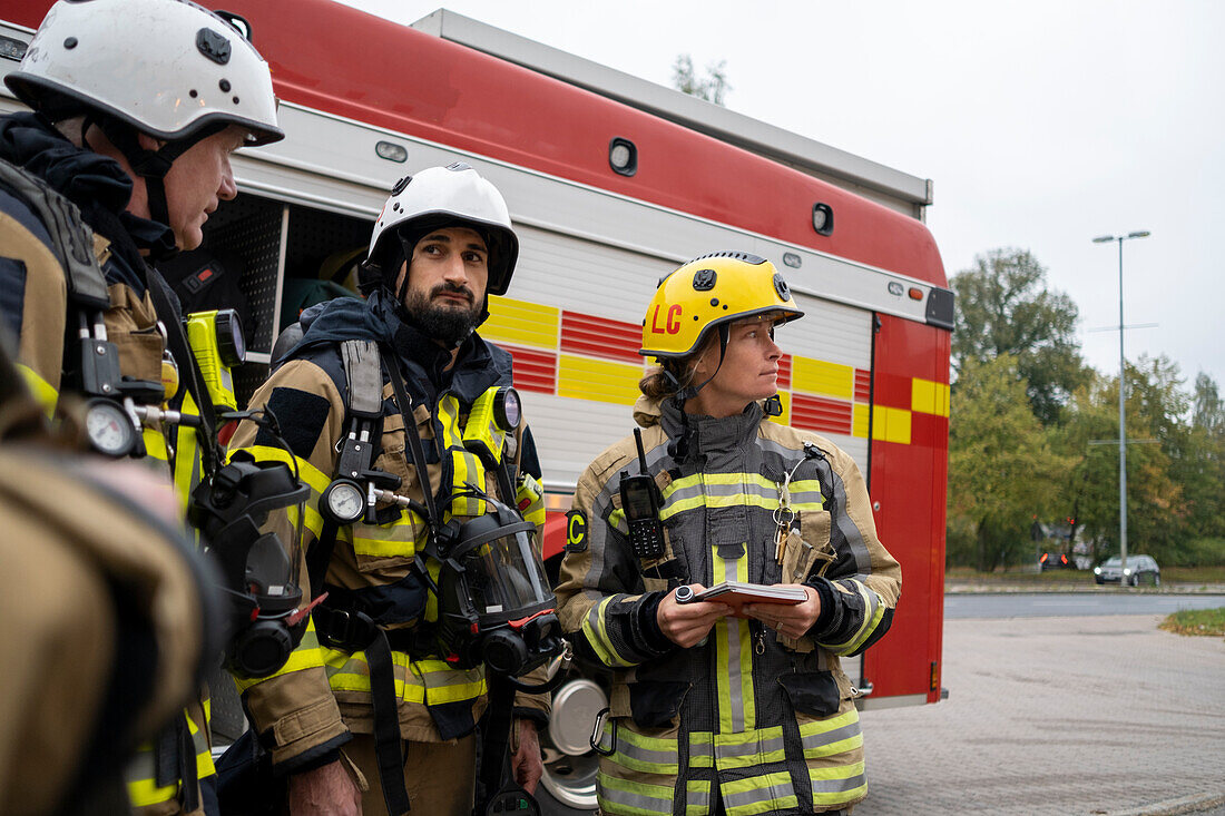 Firefighters in front of fire engine