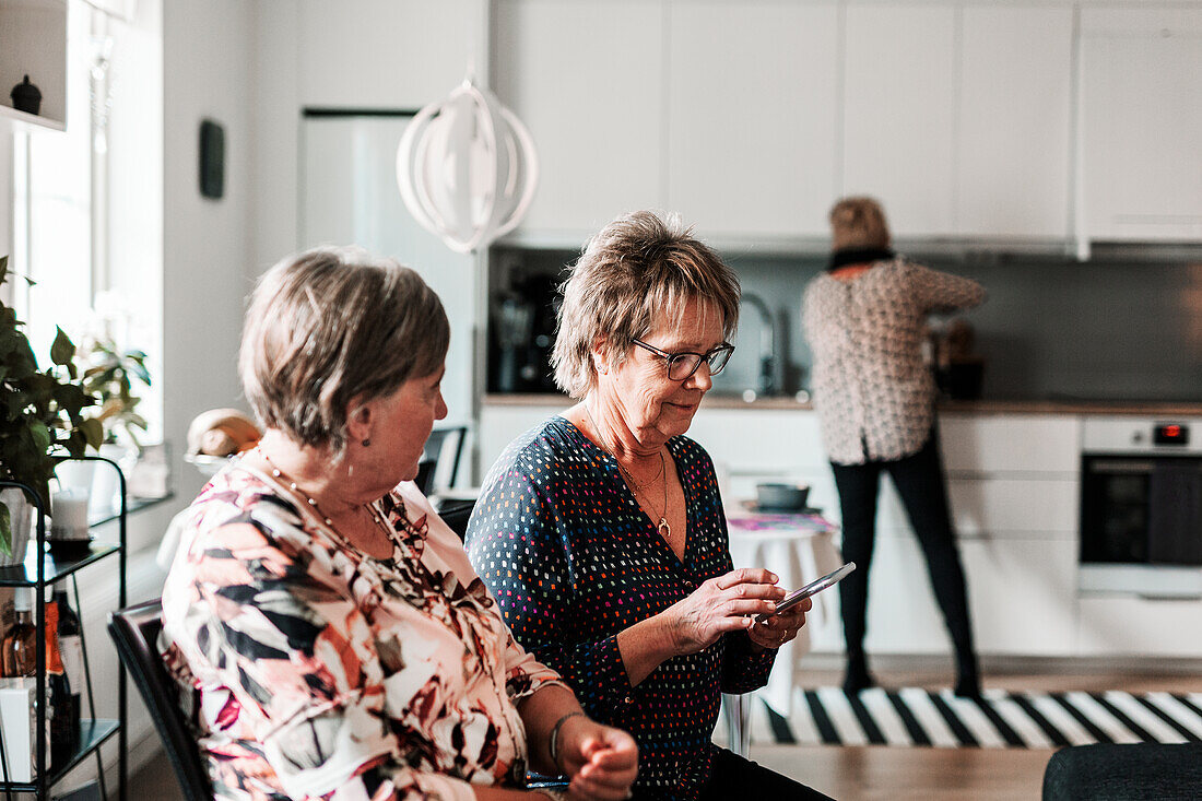 Senior women talking at home