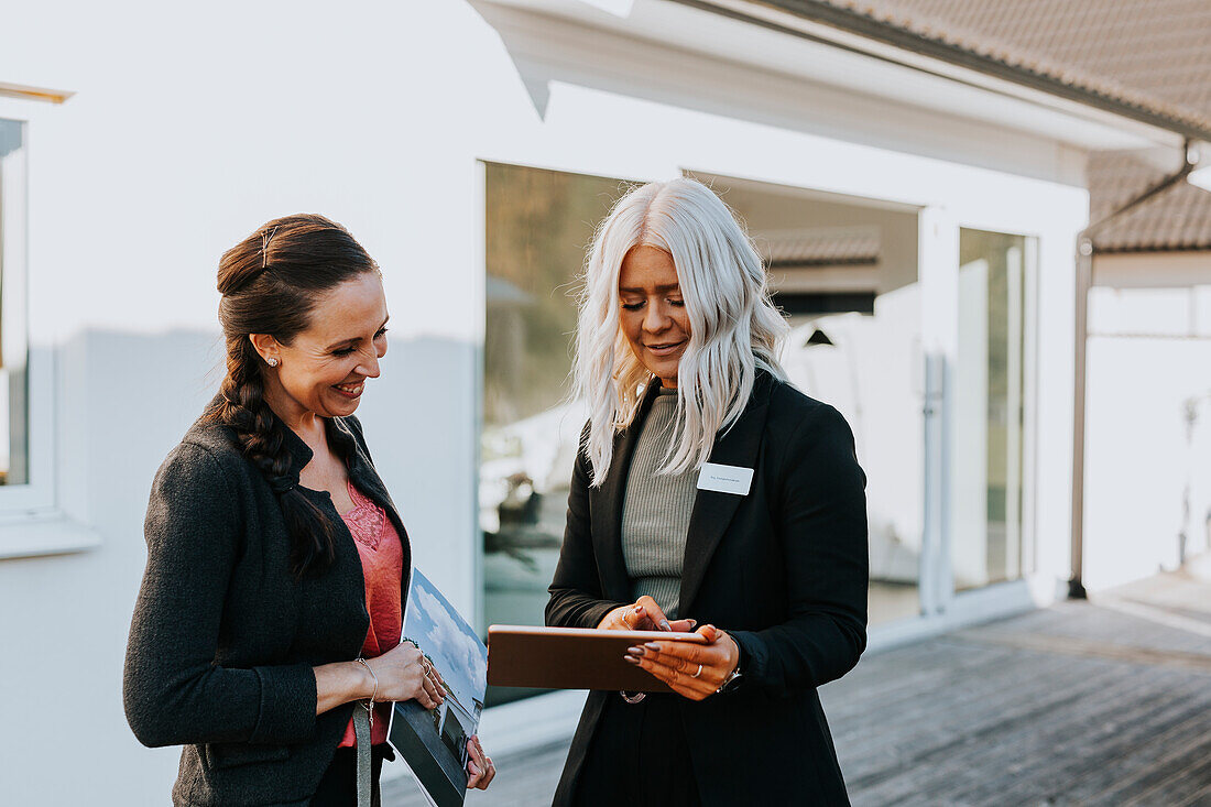 Estate agent showing woman house