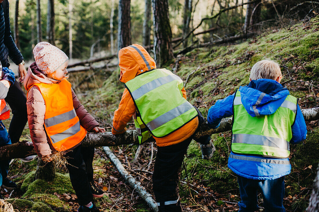 Rear view of children wearing reflective vests