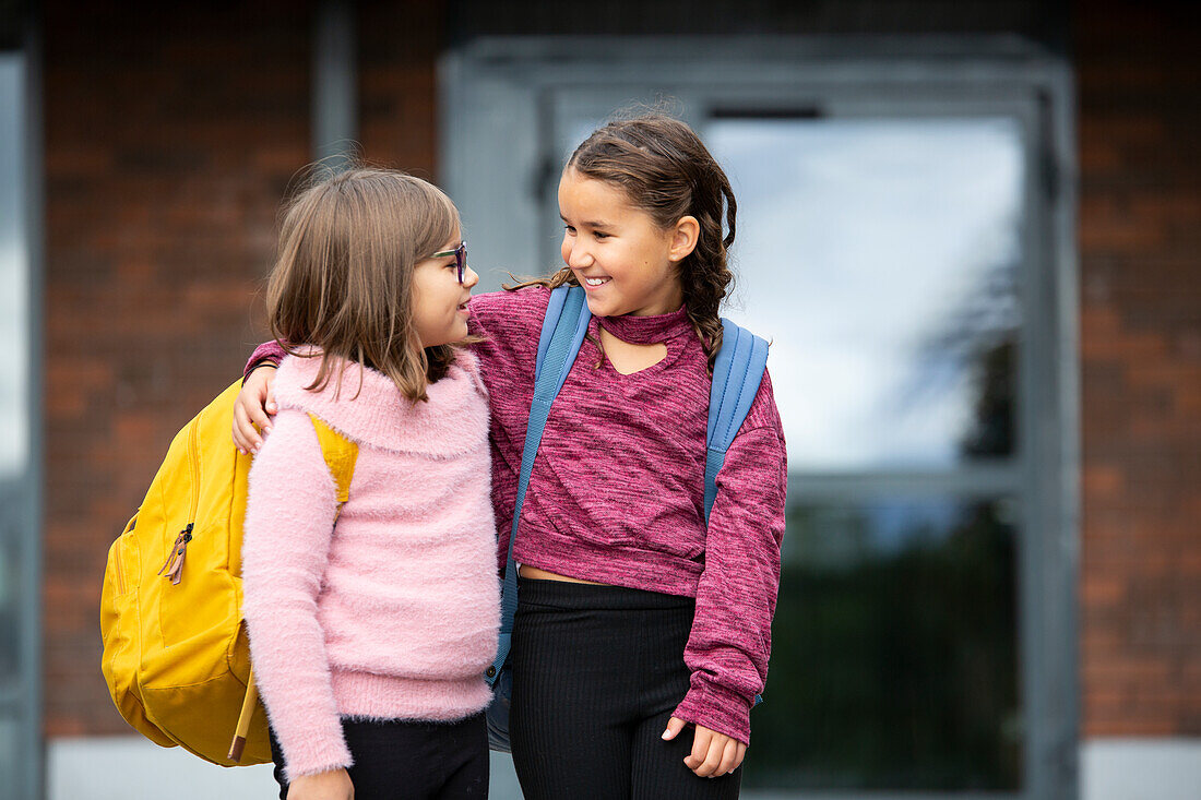 Girls standing in front of school