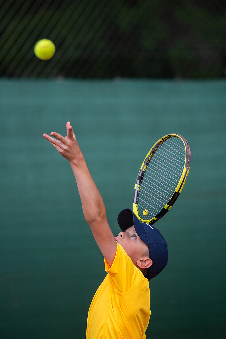 Boy playing tennis