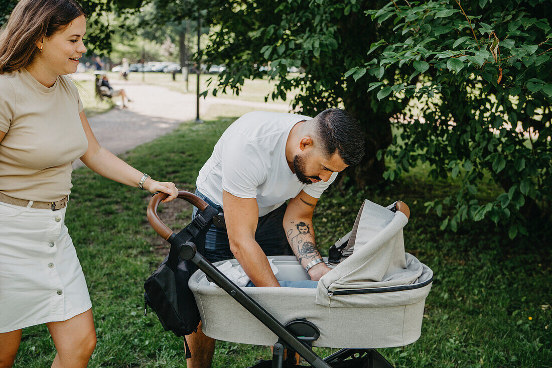 Parents with pram in park