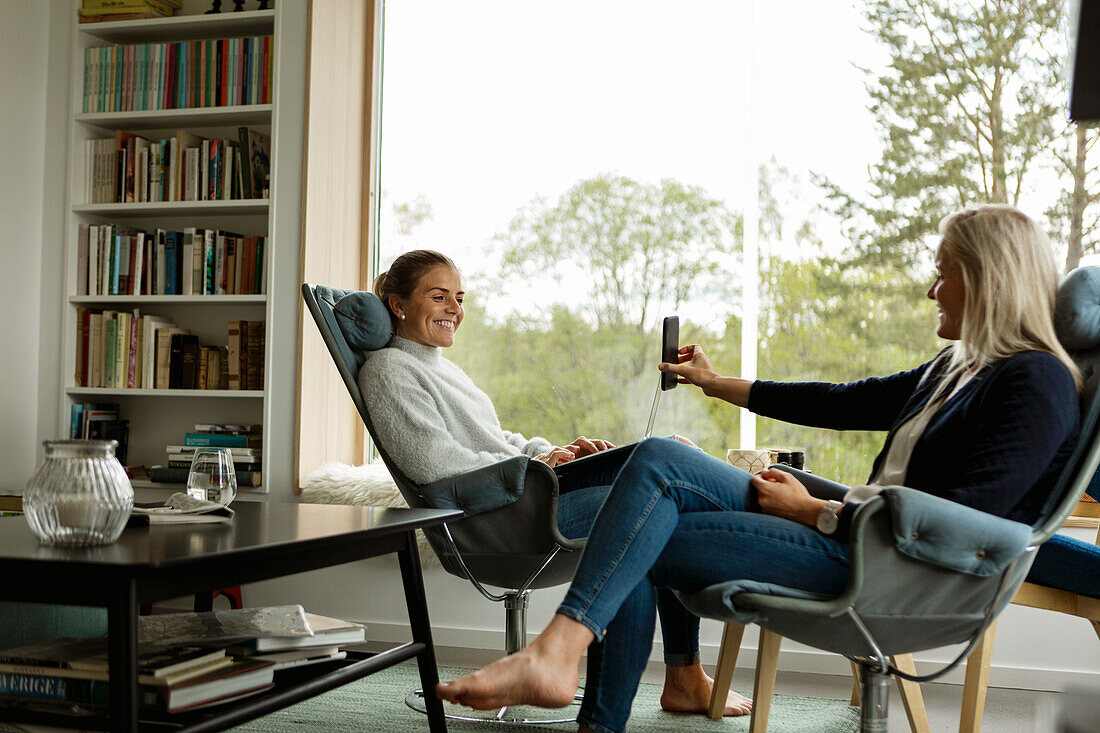 Two women relaxing in living room