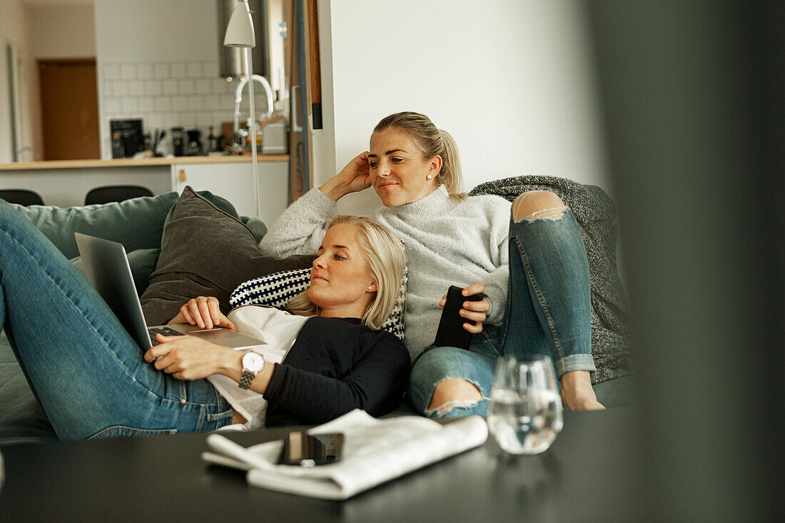 Two women relaxing in living room