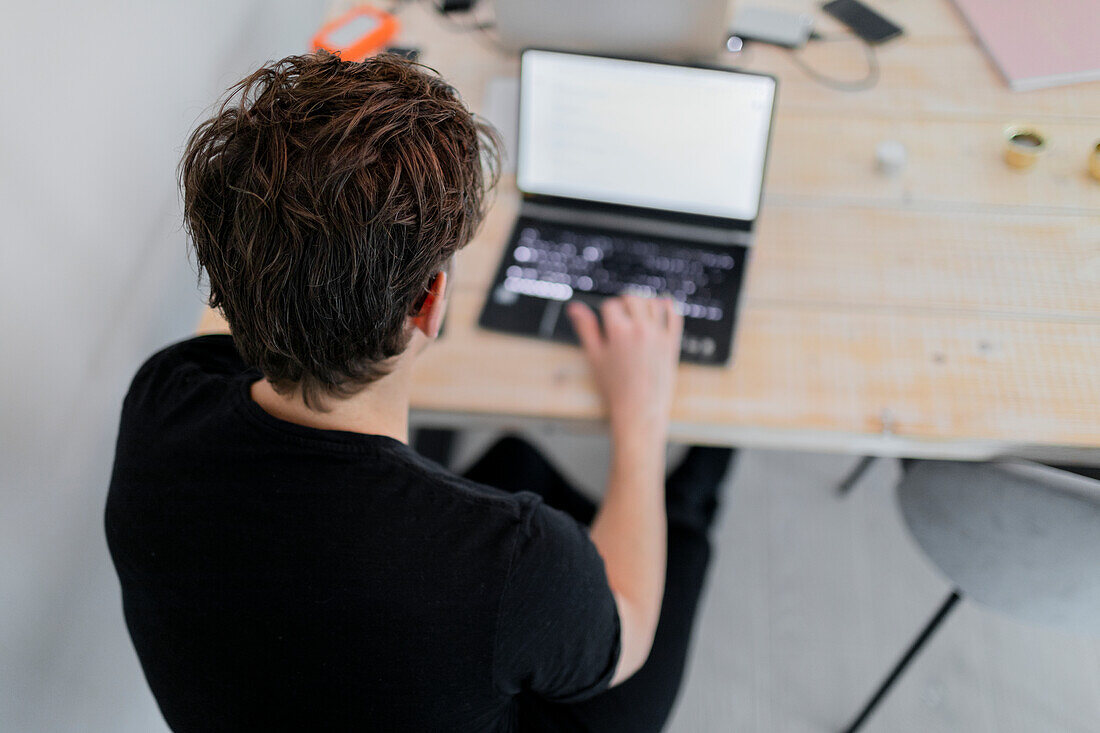 High angle view of man using laptop at home