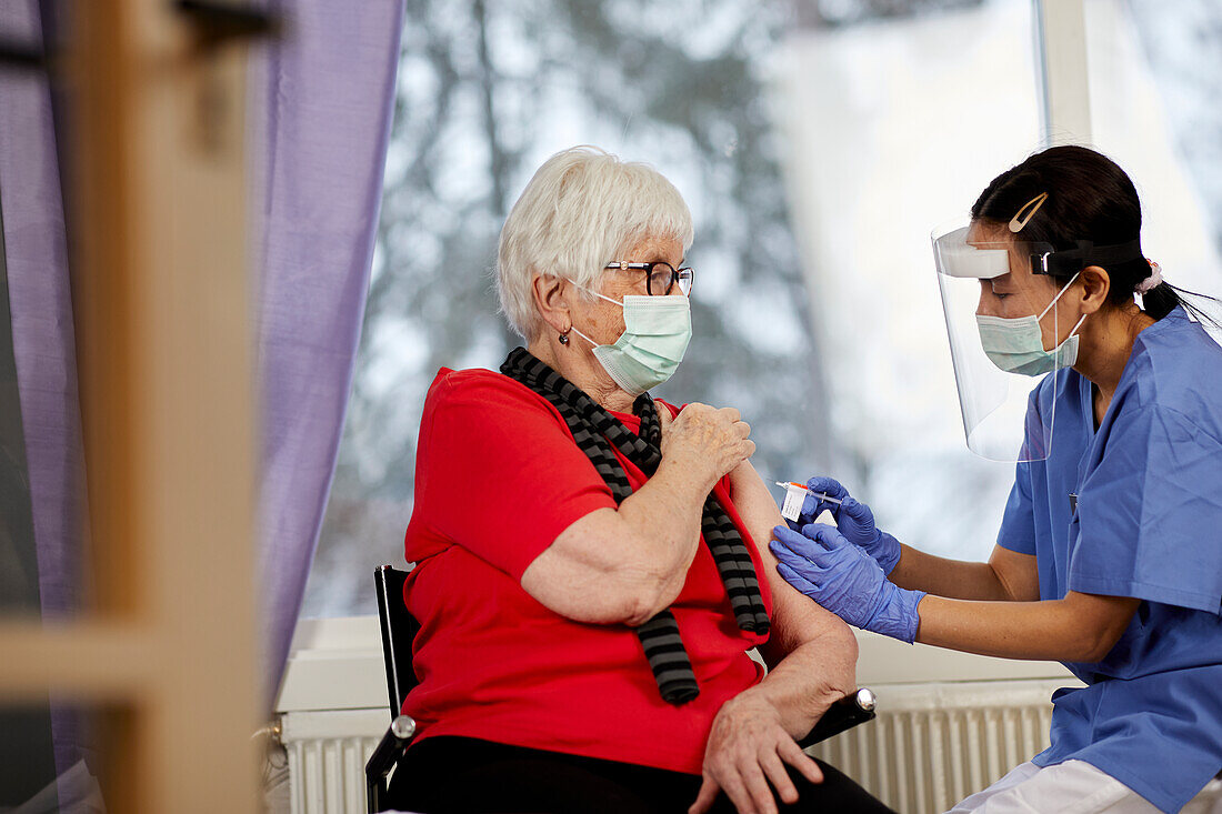 Senior woman getting covid vaccine