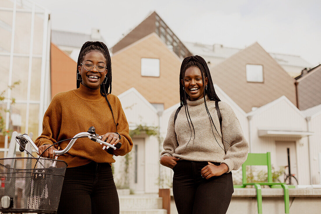 Happy female friends looking at camera