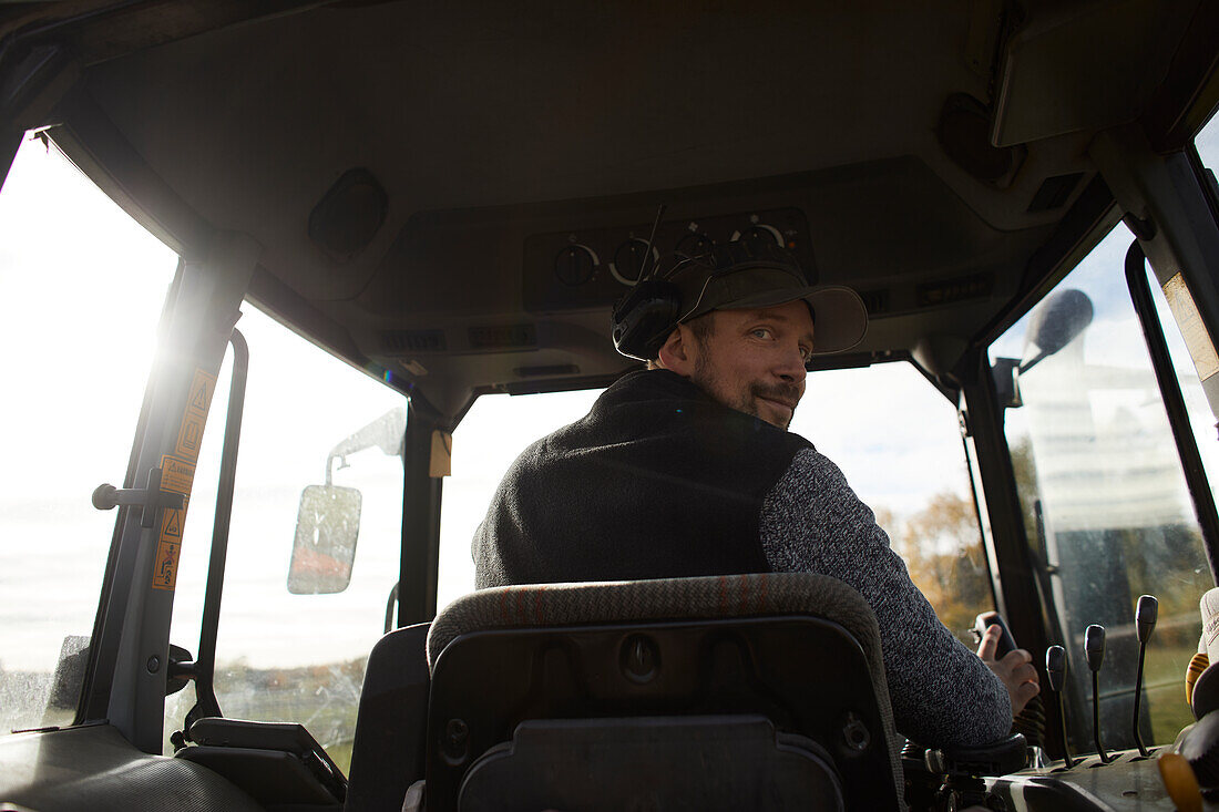 Farmer driving tractor