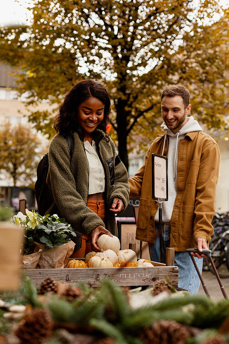 Young couple buying vegetables