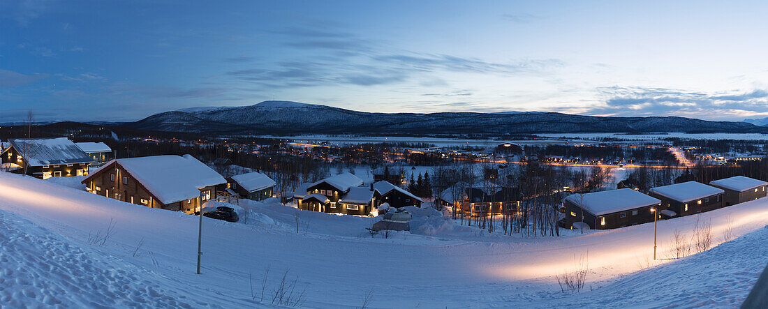 Illuminated houses in winter valley