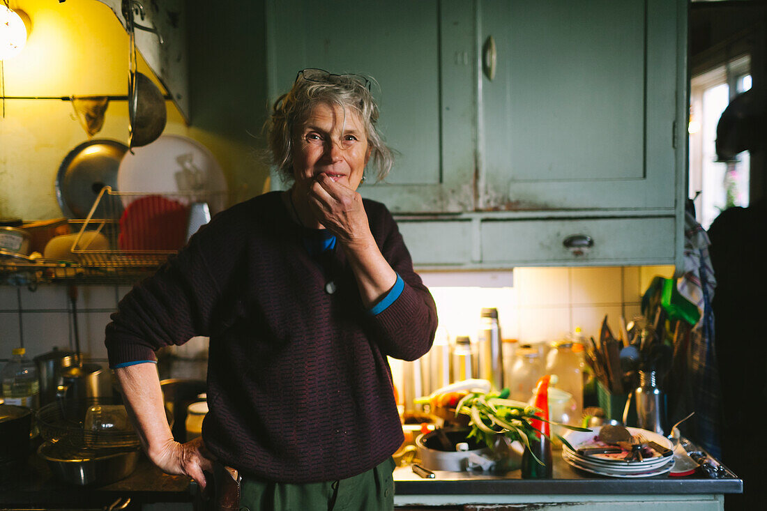 Smiling woman in kitchen looking at camera