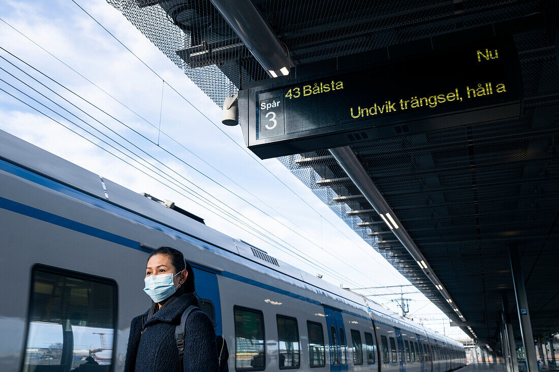 Woman on train station platform