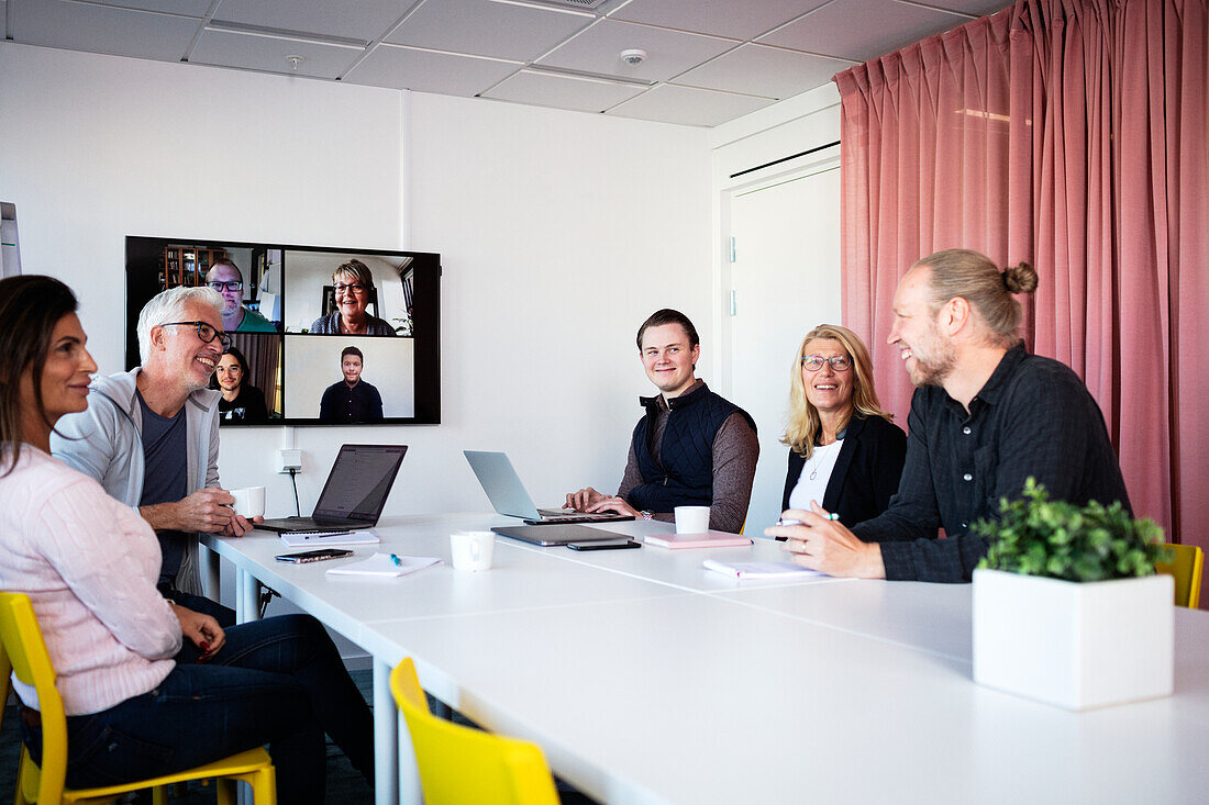 People in boardroom having video conference