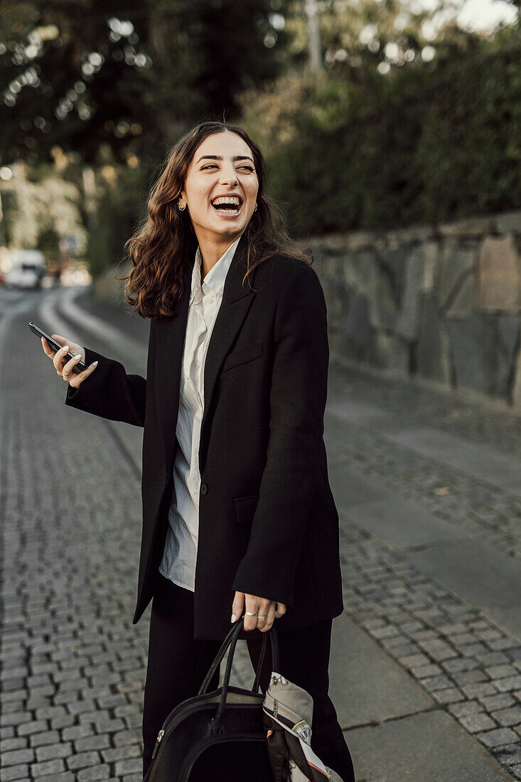 Happy businesswoman on street