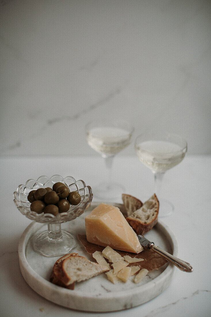 Parmesan cheese and olives on table