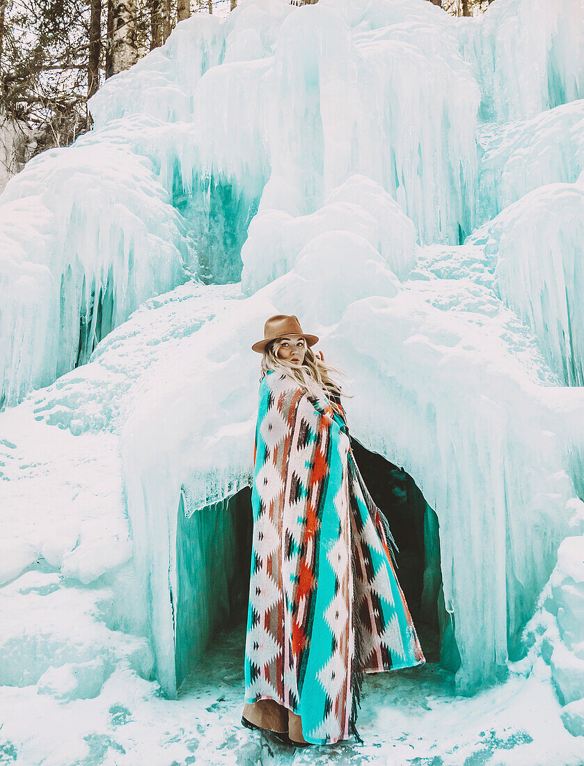 Woman in front of ice cave
