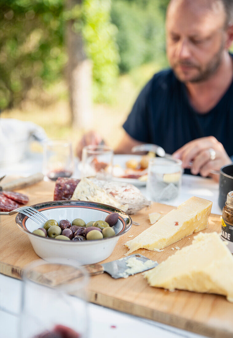 Cheese board and olives on table