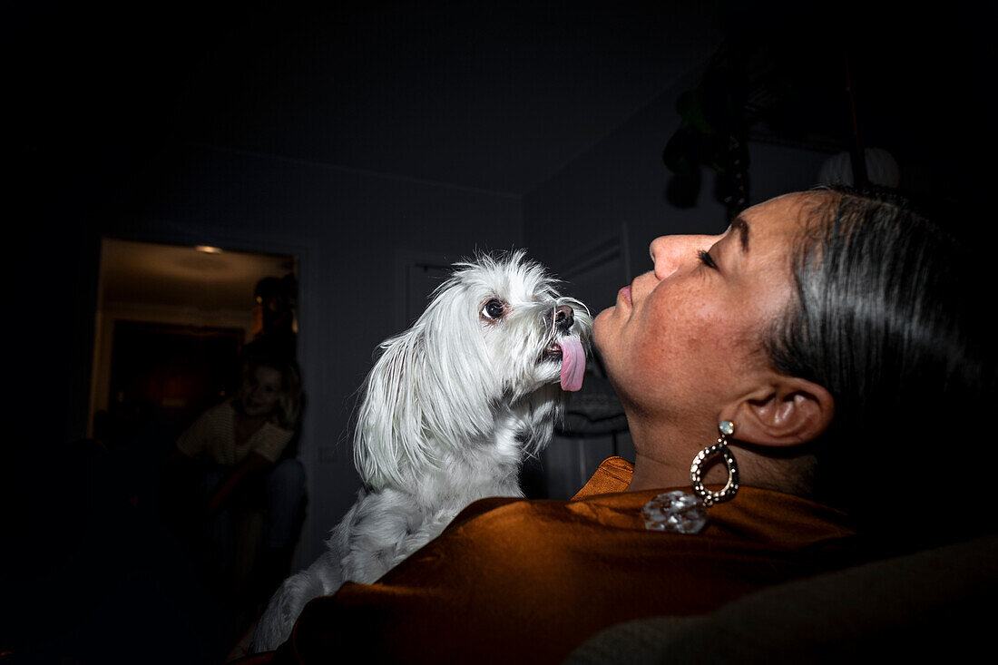 Dog licking woman's face