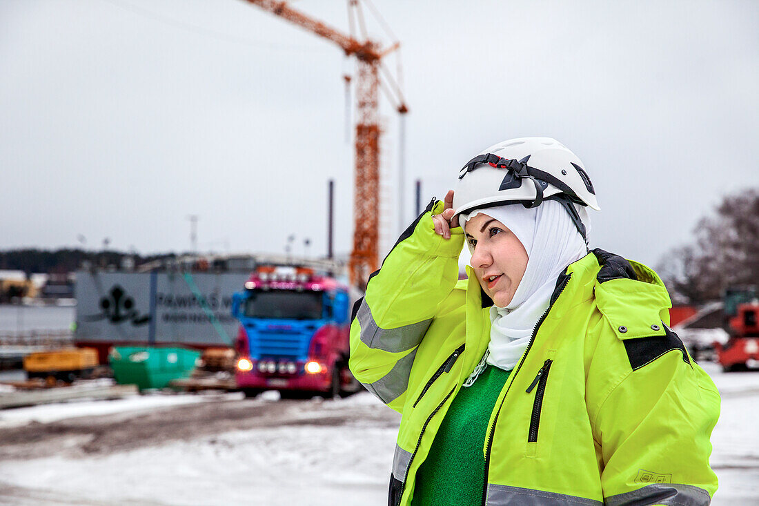 Woman wearing reflective clothing at construction site