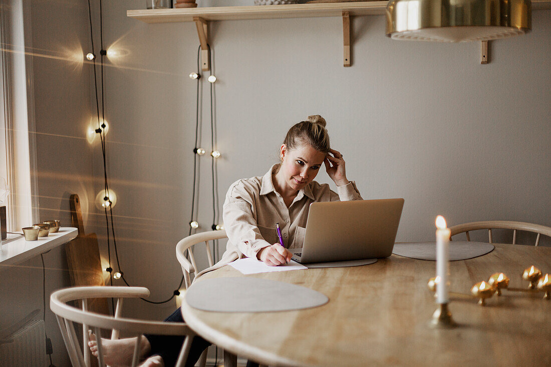 Woman using laptop at home