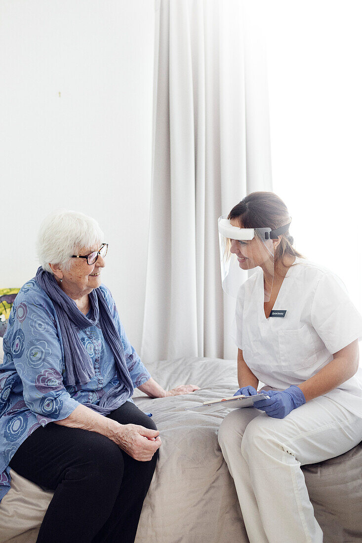 Nurse with elderly woman at home