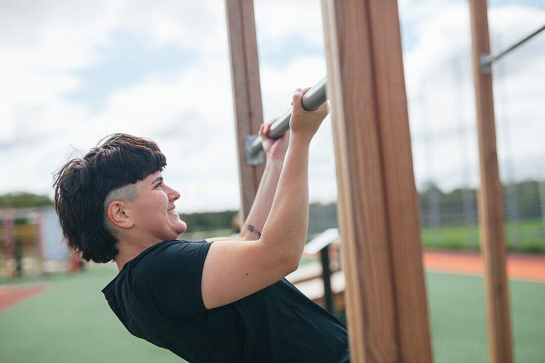 Young woman exercising at outdoor gym