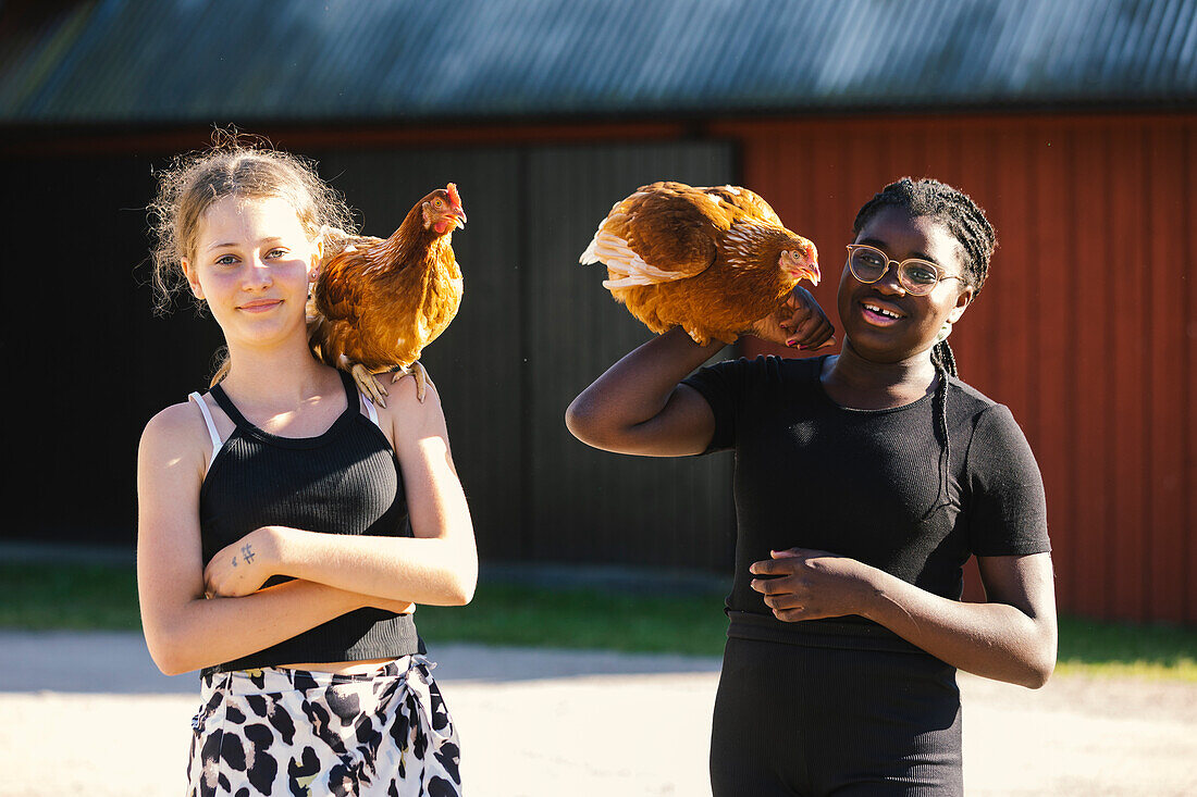 Two teenage girls with hens