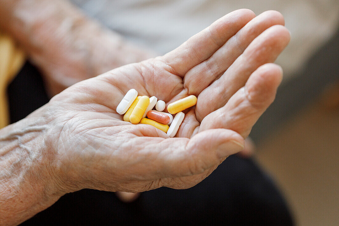 Woman's hands holding pills
