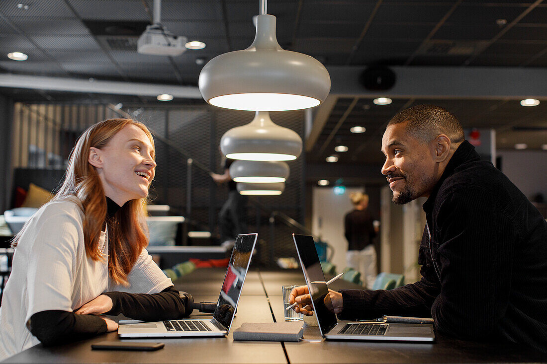 Coworkers talking in office