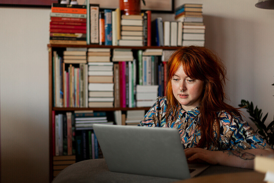 Woman in living room using laptop